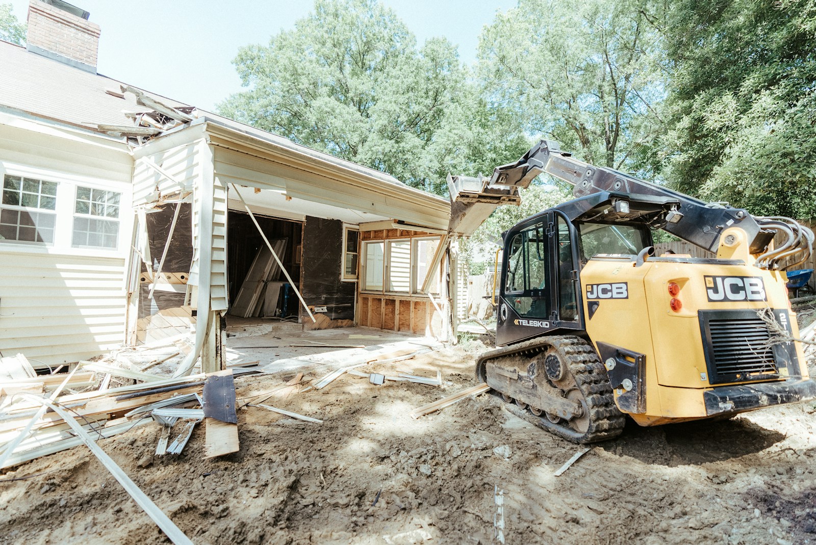 a bulldozer is parked in front of a house, contractors insurance