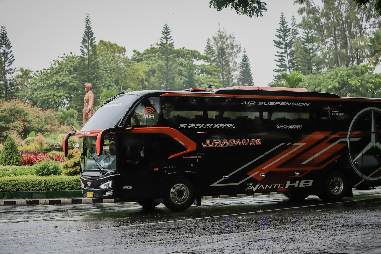 a black bus on a road, commercial auto